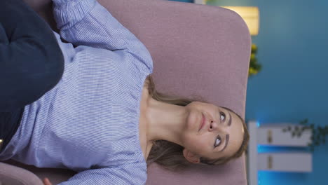Vertical-video-of-Woman-lying-on-the-sofa-is-resting.